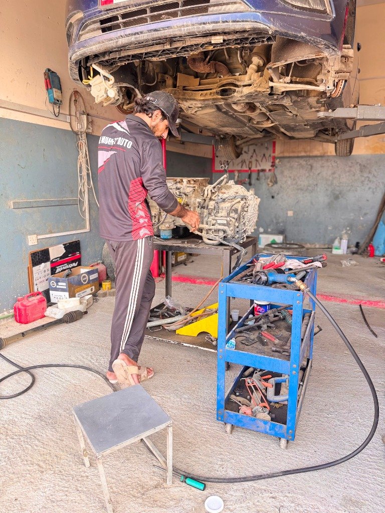 Al Muheet Auto technician performing auto electrical diagnostic work