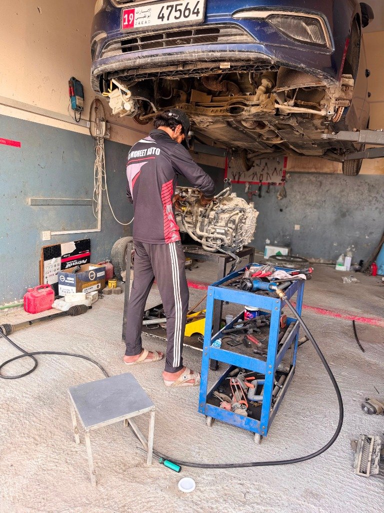 Technician in Al Muheet Auto uniform performing engine and mechanical repair